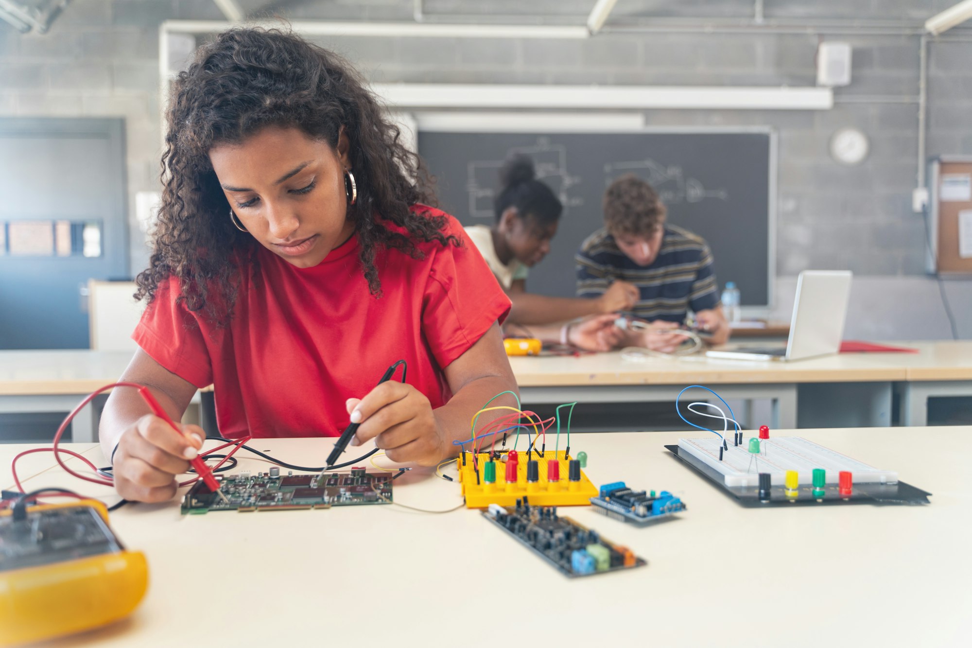 African American female teenager Student working on electronics robotics in the technology course