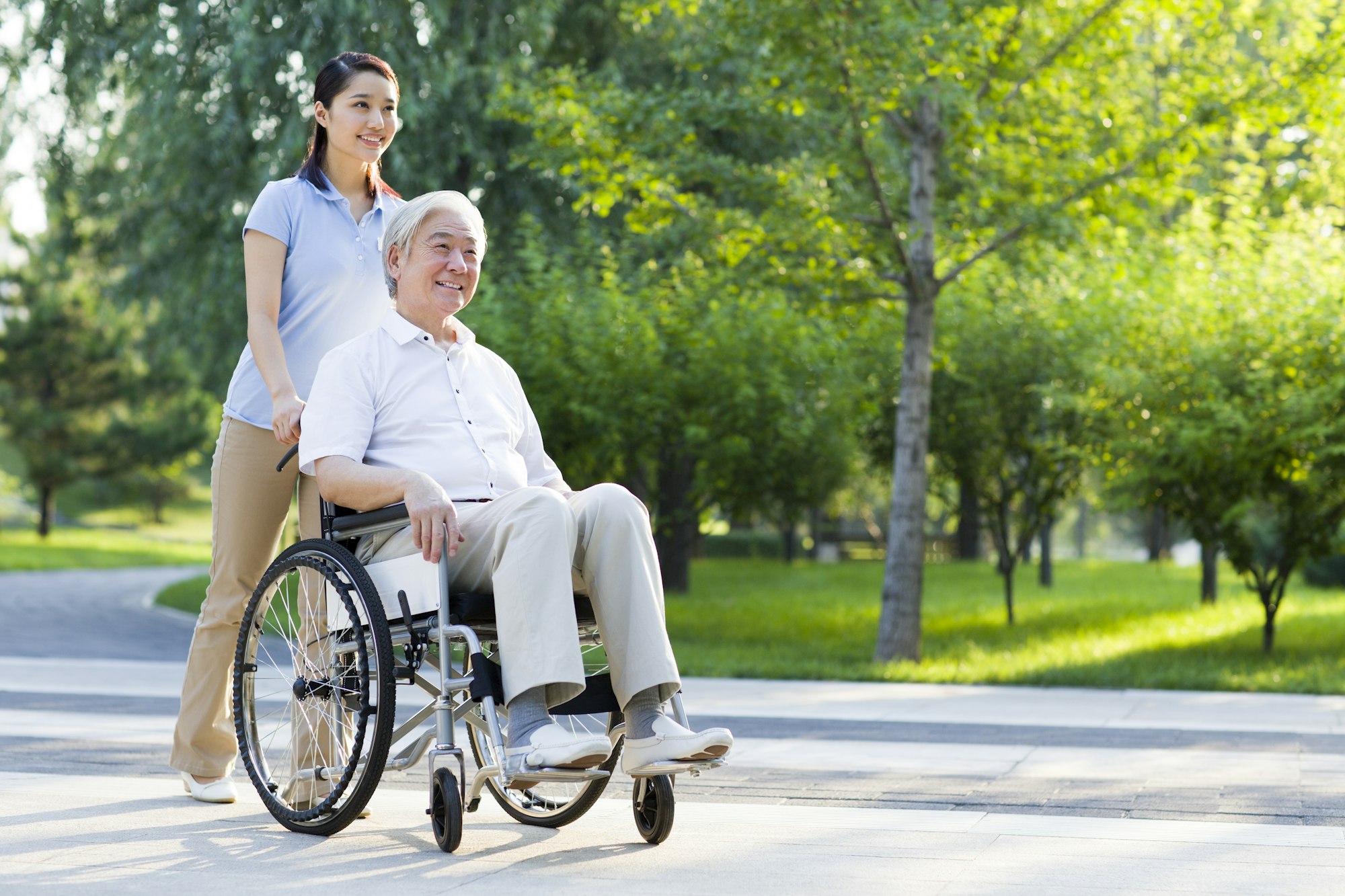 Wheelchair bound man with nursing assistant